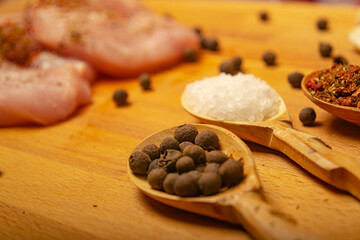 Meat steaks and various spices on a wooden Board. Close up.