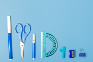 blue school stationery on a blue background. Concept back to school. Study concept. Stationery store concept. Copy space, flat lay, top view, monochrome