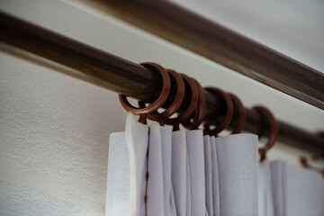 Curtain hanging with curtain ring on rod.