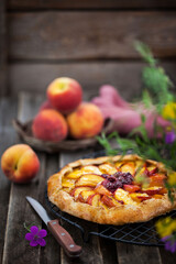 Rustic open pie (galette) with peach and cherry