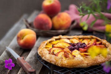 Rustic open pie (galette) with peach and cherry