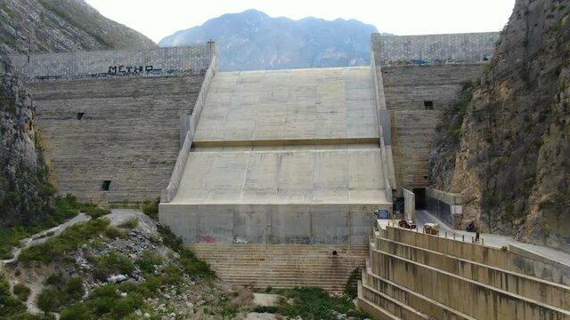 Big cement dam built on beautiful valley through rocky mountains in La Huasteca, Monterrey