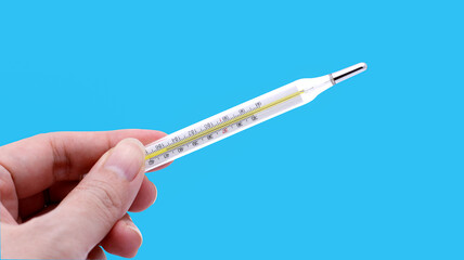clinical thermometer in hand