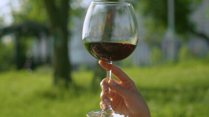 Glass of wine in the woman's hand