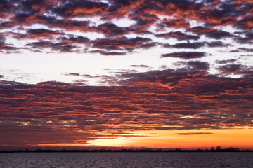 View in winter with beautiful rising sun above the Lake Tjeukemeer in the province of Friesland in the Netherlands