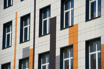 facade of a modern building on a bright Sunny day, siding and Windows, beautiful exterior of the new building