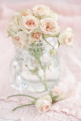Still life with a pink roses in a glass vase. Beautiful fresh flowers on a table.