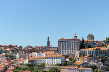 Fototapeta na wymiar Colorful houses of Porto Ribeira, traditional facades, old multi-colored houses with red roof tiles on the embankment in the city of Porto, Portugal. Unesco World Heritage site.