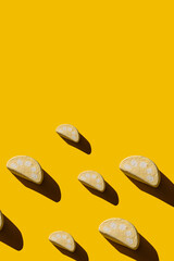 Pattern of tasty marshmallows with hard shadows on a yellow background.