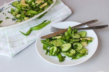 healthy, summer salad of avocado, cucumber, sugar pea pods