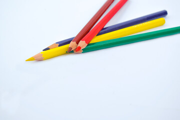 Different color wood pencil crayon placed two on top of three pencil crayons