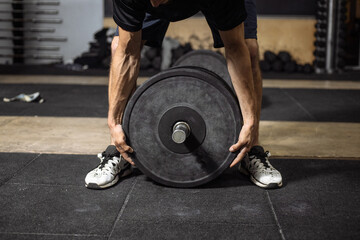Athletic man holding a bar Handsome strong bodybuilder athletic man pumping up muscles workout concept background - muscular bodybuilder handsome men doing exercises in gym sport 
