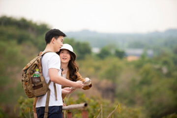 Asian traveler  couple holding map  walking at natural park enjoy view