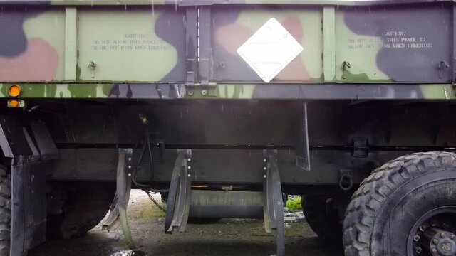 M977 Oshkosh Hemtt 8x8. The Heavy Expanded Mobility Tactical Truck Aerial Panramic Pan To The Left On A Rainy Summer Day. 3-3