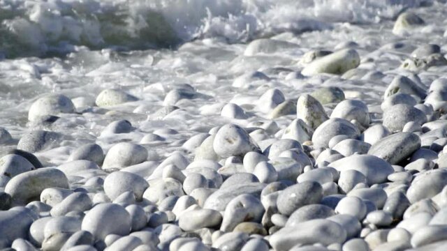 Waves Splashing On The Kiesel Beach In Greece.  - close up shot