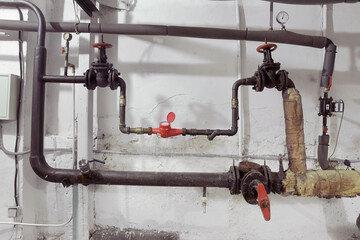Faucets on old water pipes. Emergency. Basement Heating System