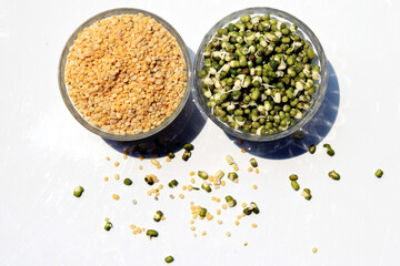 Fresh, healthy sprouted mung dal or moong beans. Toor dal ( skinned and split pigeon pea ) in a bowl. Yellow moong dal, skinned and split mung bean.