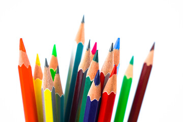 A huge pile of different colored wood pencil crayon placed on a white background
