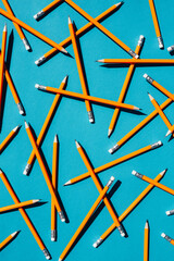 Background of blue color with many simple pencils.
