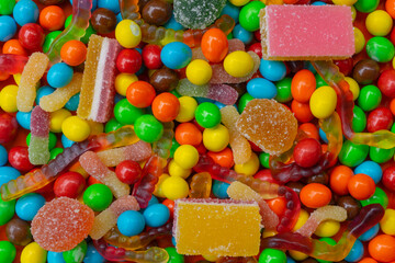 Colorful background from multi-colored sweets and marmalade.