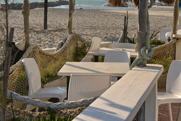 white empty seats at beach patio with sea view in italy