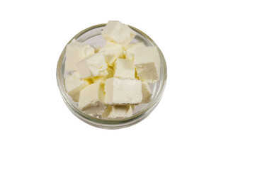 Feta cheese cubes in glass bowl isolated on white background