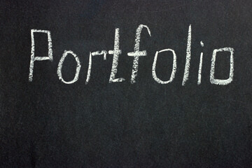 
The inscription on the black board "Portfolio". Collection of the best freelancer works