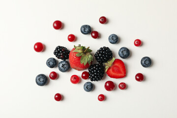 Mix of fresh berries on white background, top view