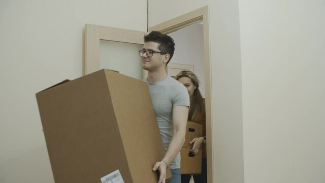 Young european couple moving into a new apartment . Charming lovers looking around the room and estimating the amount of future repair work. Concept of young family, new beginning and future.