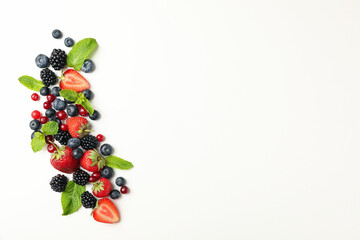 Fresh berries with mint leaves on white background, top view