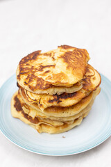 Top view of stacked pancakes served on the plate