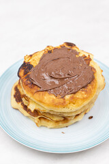 Top view of pancakes with chocolate cream on the plate