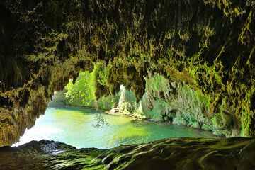 beautiful cave and green lake - obrazy, fototapety, plakaty