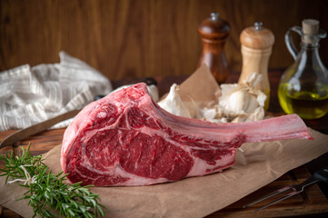fresh tomahawk, ribeye steak meat on wooden cutting board