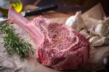 Gartenposter seasoned tomahawk steak meat on wooden board © ahirao