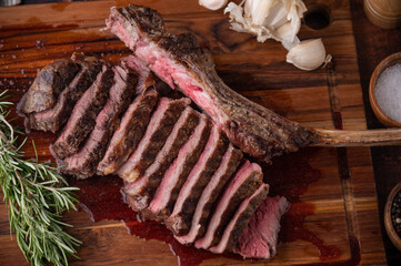 grilled tomahawk steak on wooden board