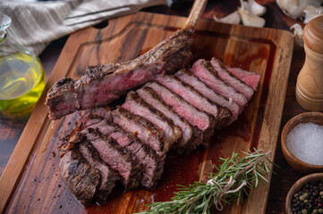 grilled tomahawk steak on wooden board