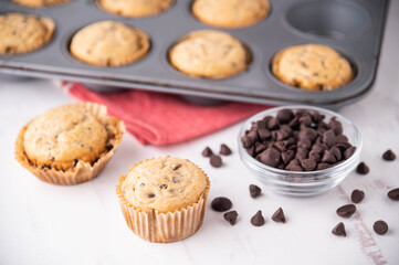 chocolate chip muffin on white wooden board