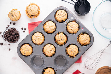 chocolate chip muffin on white wooden board