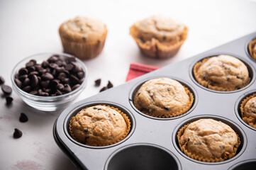 chocolate chip muffin on white wooden board