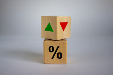Wooden cubes changes the direction of an arrow symbolizing that the interest rates are going down...