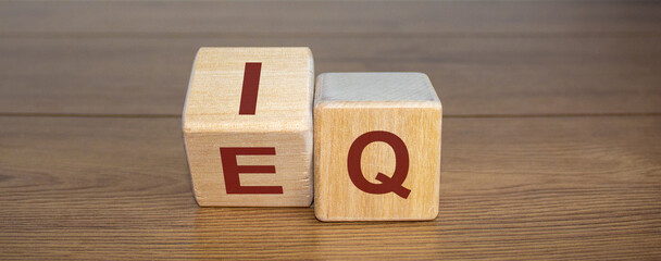 Wooden cubes with the expression 'IQ' 'Intelligence Quotient' to 'EQ' 'Emotional Intelligence...