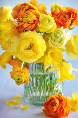 Naklejka na ściany i meble Spring bouquet of a yellow flowers on a blue light background. 
