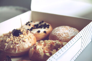Assorted donuts with different fillings in cardboard box
