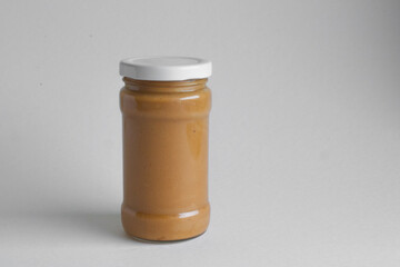 jar of peanut butter on a white background 