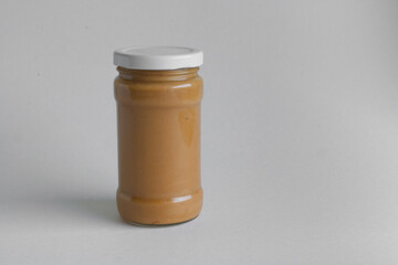 jar of peanut butter on white background