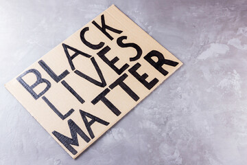 No racism concept on a gray background. Cardboard banner. Concept of the struggle for equality. Copy space