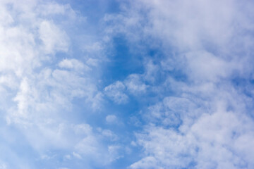Blue sky with gentle haze of white clouds on sunny summer day