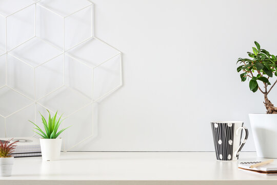 Minimal business desk. Blank wall copy space. Front view. Geometric toolbox.