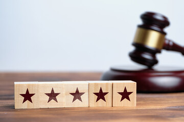 Rating concept from the path of 5 stars on wooden blocks with a hammer judge
